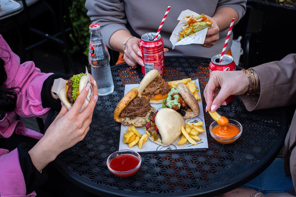 three people at a table with food